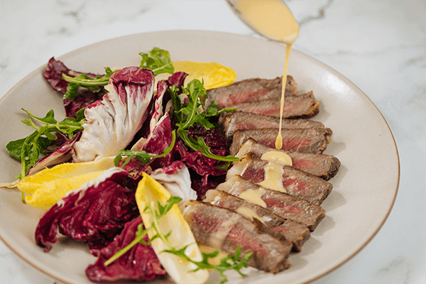 Garlic and Herb Marinated New York Steak with Chicories and Balsamic Dressing
